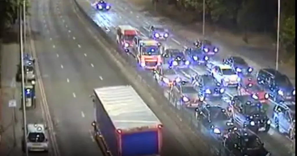 A woman remains critical after being involved in a collision with a police motorcycle in West London