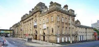 Detectives investigating a stabbing in Blackburn have charged two men