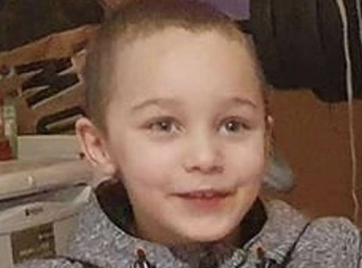 Two adults and a teenager have appeared in court after the body of a five-year-old boy was found in a river