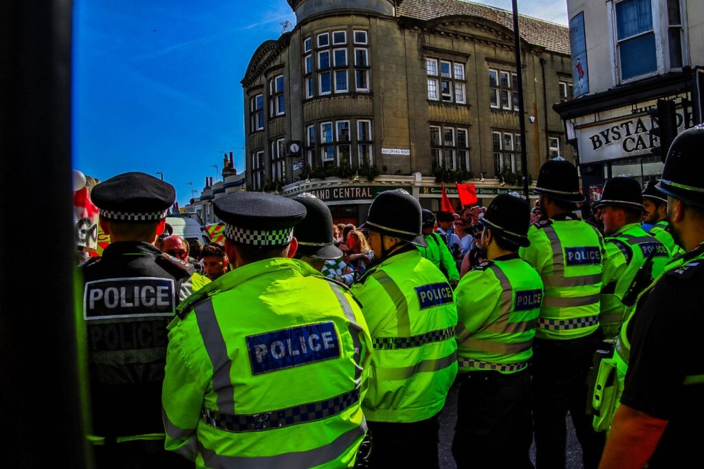 Eight Held Following Clashes Between Rival Protesters Drawing Thousands to City Centre